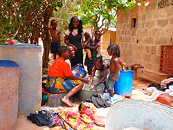 Women doing laundry while chatting in a public space