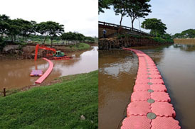 Garbage collection equipment across a river (floating booms).